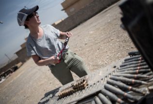 Field investigator photographing captured ISIS ammunition, West Mosul